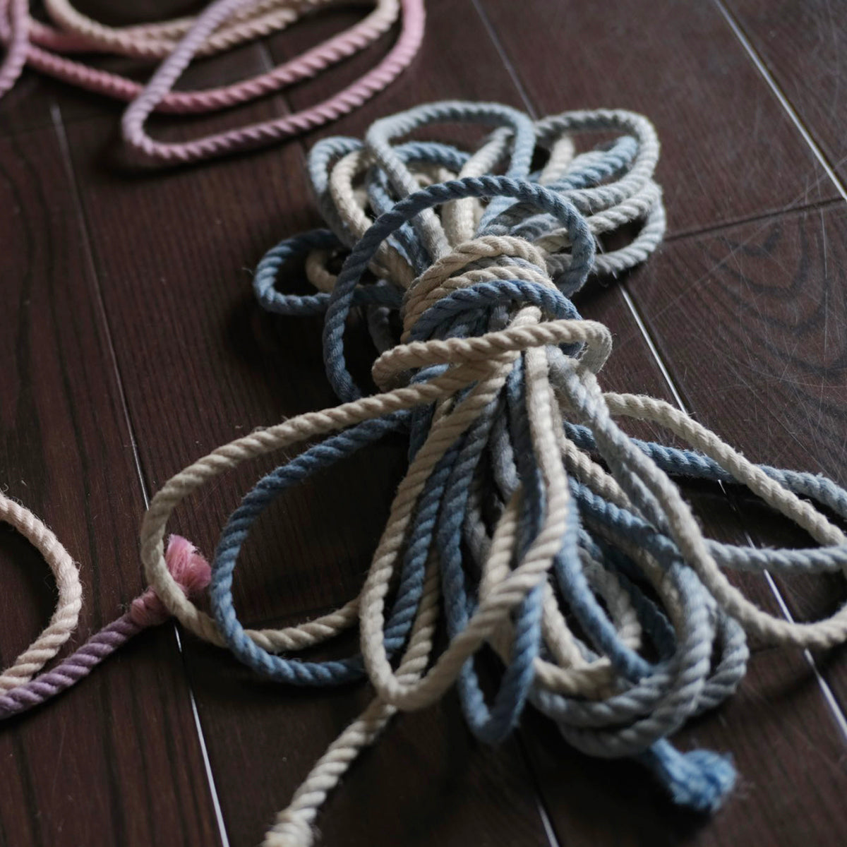 Close-up of ready-to-use blue gradient 6mm hand-braided jute Shibari rope by Sexy Maker, pre-treated and singed to prevent rope burn.