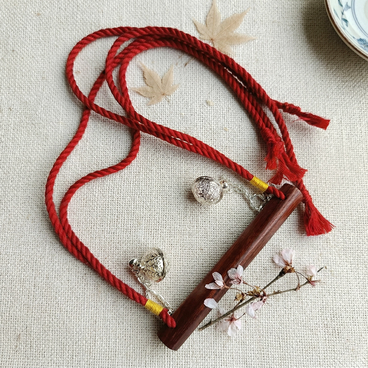 Authentic Japanese BDSM wood gag with crimson red jute rope and sensory bells for Shibari and Kinbaku roleplay by Sexy Maker.
