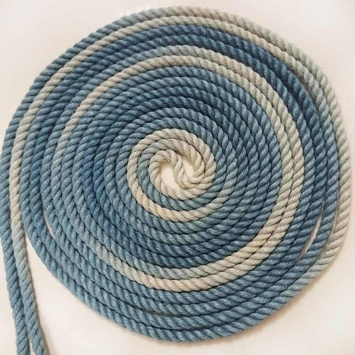 Close-up of ready-to-use blue gradient 6mm hand-braided jute Shibari rope by Sexy Maker, pre-treated and singed to prevent rope burn.
