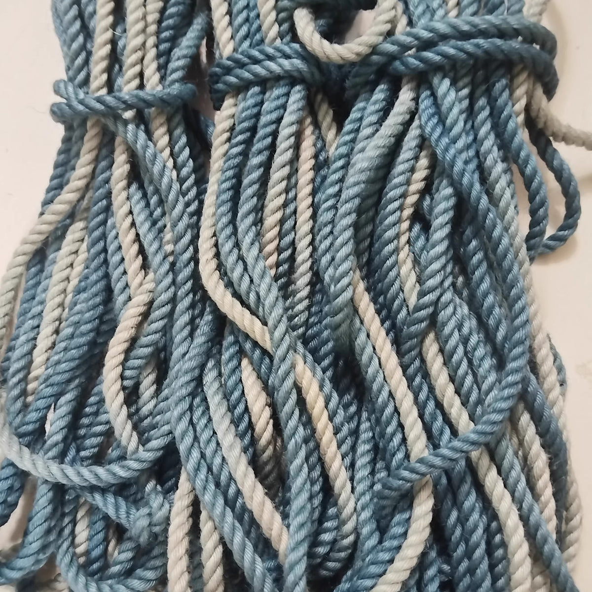 Close-up of ready-to-use blue gradient 6mm hand-braided jute Shibari rope by Sexy Maker, pre-treated and singed to prevent rope burn.