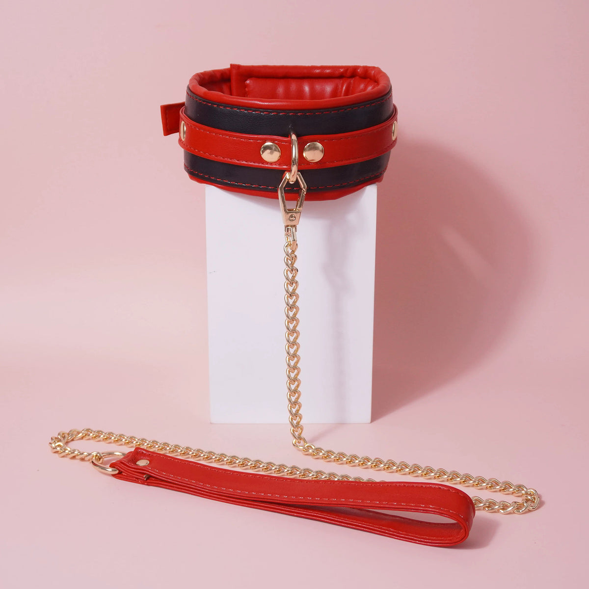 Close-up of the complete 7-piece premium vegan leather bondage starter set featuring padded cuffs, collar, and paw print paddle by Sexy Maker.