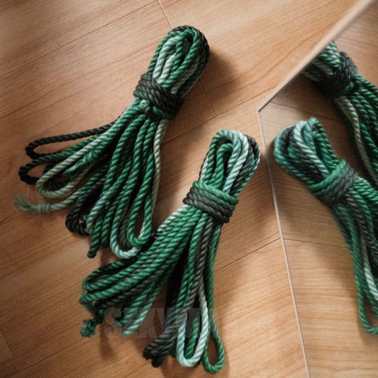Close-up of premium treated 6mm jute Shibari rope in a dark to light green gradient for authentic Kinbaku and rope bondage by Sexy Maker.