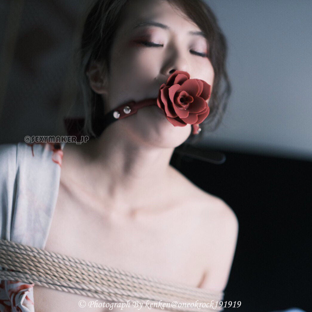 Close-up of breathable red silicone rose ball gag with adjustable vegan leather straps for aesthetic BDSM play by Sexy Maker.