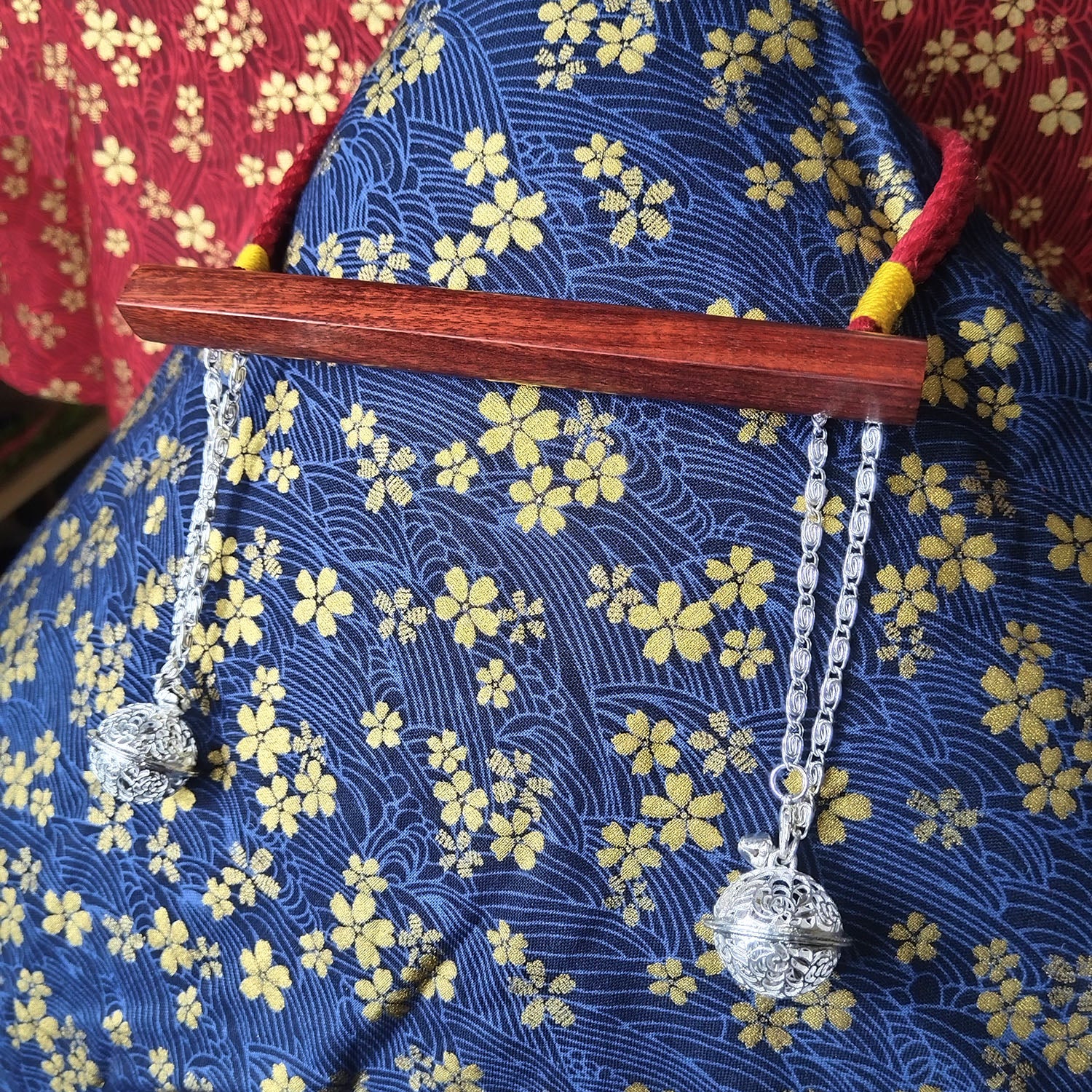 Authentic Japanese BDSM wood gag with crimson red jute rope and sensory bells for Shibari and Kinbaku roleplay by Sexy Maker.