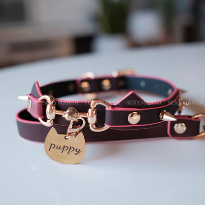 Close-up of heat-reactive color-changing black to red pet play collar featuring spiked cat ears and a gold puppy charm by Sexy Maker.