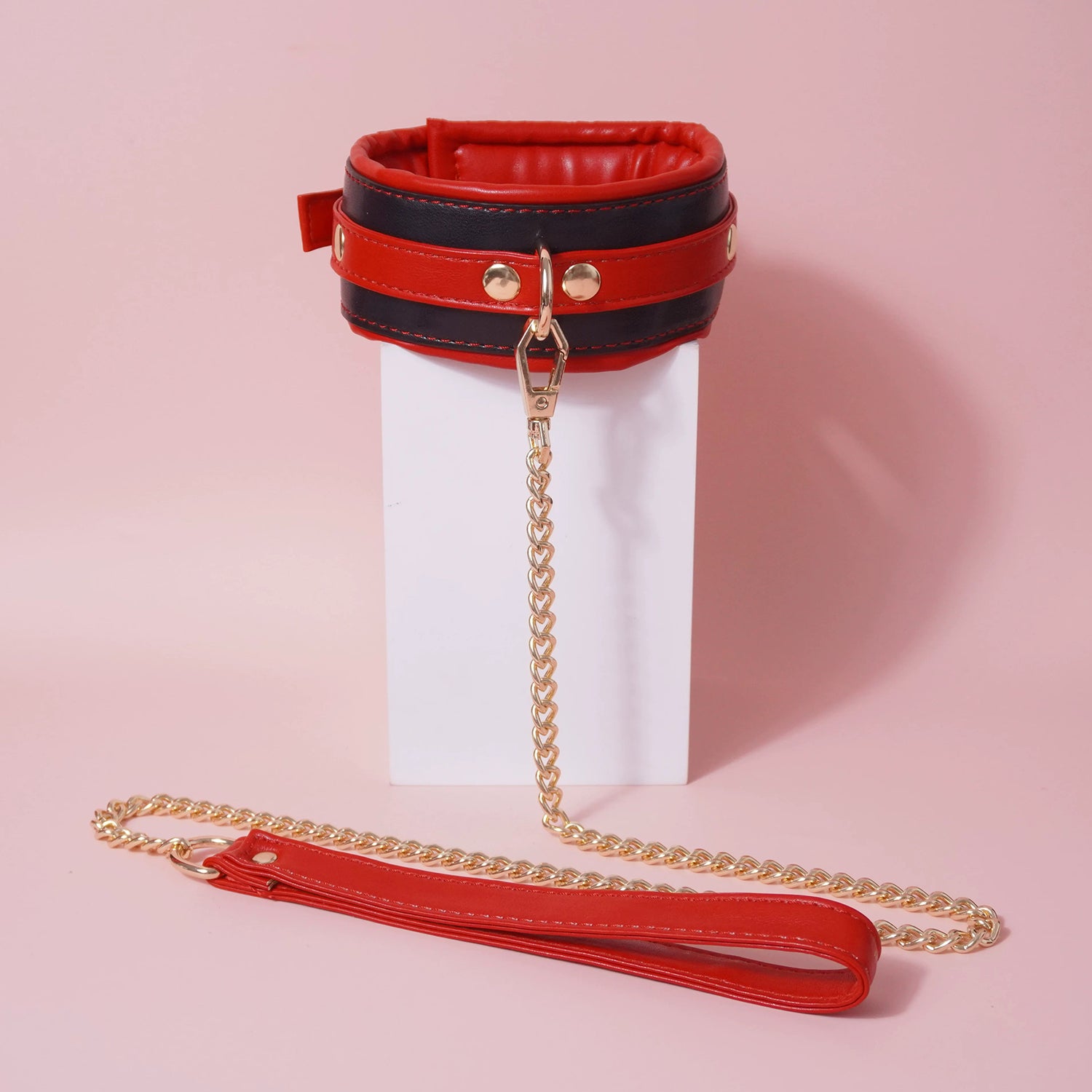 Close-up of the complete 7-piece premium vegan leather bondage starter set featuring padded cuffs, collar, and paw print paddle by Sexy Maker.