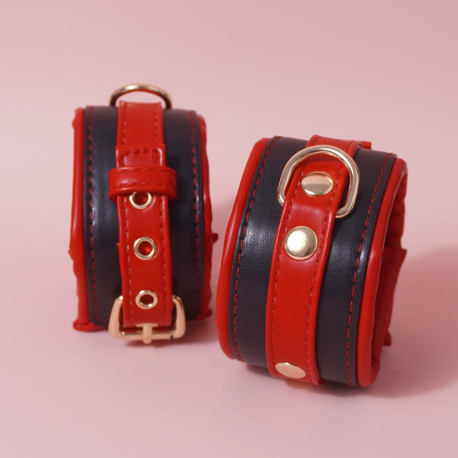Close-up of the complete 7-piece premium vegan leather bondage starter set featuring padded cuffs, collar, and paw print paddle by Sexy Maker.