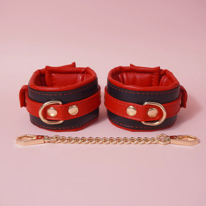 Close-up of the complete 7-piece premium vegan leather bondage starter set featuring padded cuffs, collar, and paw print paddle by Sexy Maker.